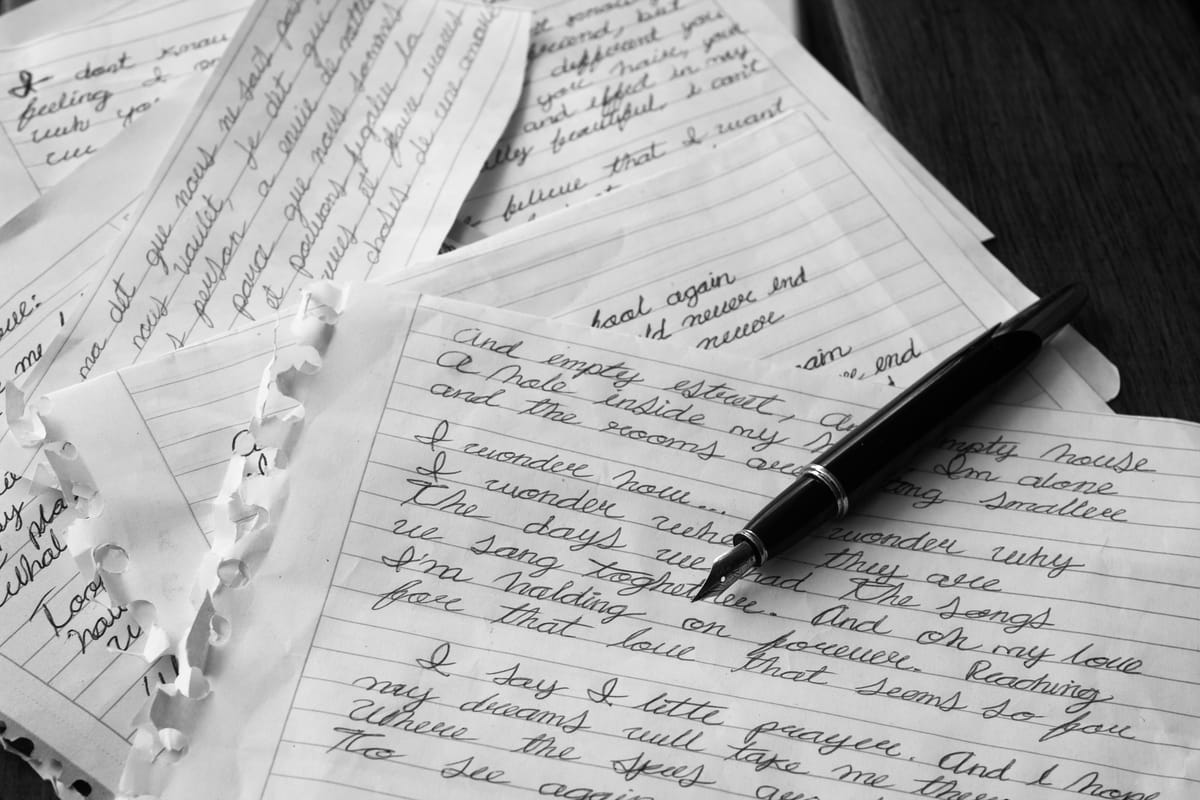 Fountain pen on handwritten notes about rewriting your story and healing from heartbreak.